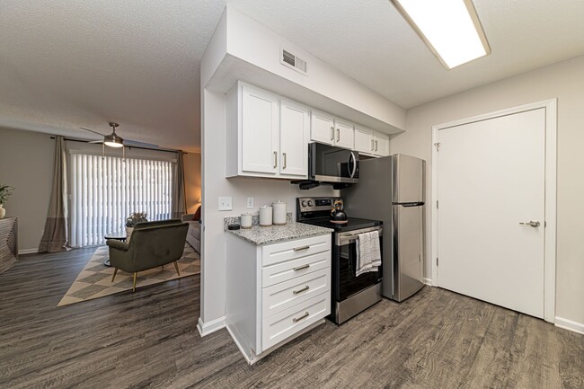 Kitchen with modern cabinetry & stainless appliances - The Wesley Apartment Homes