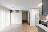 Located at 1101 Northwest 39th Avenue in Gainesville, Florida, this compact yet thoughtfully designed one-bedroom, one-bathroom unit makes excellent use of its space across a single floor. The open-concept kitchen and living area forms the heart of the unit, with light wood-look flooring running throughout. The kitchen is well-appointed with stainless steel appliances — including a refrigerator, range, and over-the-range microwave — complemented by gray shaker-style cabinetry and light granite-look countertops. A wall-mounted mini-split system provides efficient climate control in the living area, which also benefits from natural light through blinded windows and a sliding glass door. A distinctive architectural detail — a decorative open-grid block partition wall — visually separates the living space, adding character to the interior. The bedroom offers a comfortable footprint with a window for natural light and direct access to two closets, providing ample storage. The bathroom features a full bathtub with tiled surround, a white vanity with sink, and wood-look flooring that ties the space together. Clean, neutral walls and modern finishes throughout give the unit a fresh, move-in-ready feel.