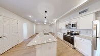 Located at 2625 Ridgewood Rd in Jackson, Mississippi, this well-designed 2-bedroom, 2-bathroom single-floor residence offers a bright, modern living experience with quality finishes throughout. The open-concept living room and kitchen area serves as the heart of the home, featuring light wood-look luxury vinyl plank flooring, recessed lighting, and a ceiling fan that enhances airflow and comfort. Arched architectural details add a subtle decorative touch to the living space.

The kitchen is a standout, equipped with white shaker-style cabinetry, granite countertops, a subway tile backsplash, stainless steel appliances including a refrigerator, electric range, and microwave, and a peninsula island with pendant lighting and a sink — ideal for both cooking and casual dining.

Both bedrooms are carpeted and offer a comfortable, quiet retreat, each featuring ceiling fans, recessed lighting, and windows with blinds that allow natural light while maintaining privacy. The primary bedroom is generously sized with a dedicated closet.

The two bathrooms are finished in a crisp, clean white palette with tile flooring, granite-topped vanities with white cabinetry, and tub-shower combinations with subway tile surrounds. The overall ambiance is fresh, modern, and move-in ready.
