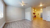 Located at 4154 Roosevelt Street in Whitehall, PA, this single-floor unit offers a practical and well-appointed layout designed to maximize every square foot. The open-plan kitchen and living area serves as the heart of the space, featuring rich, warm-toned wood cabinetry with ample upper and lower storage, light countertops, and a full suite of white appliances including a refrigerator, electric range, built-in microwave, and dishwasher. The kitchen flows naturally into the living area, which is finished with light wood-style laminate flooring that runs throughout the unit, creating a cohesive and inviting atmosphere. Neutral gray walls provide a clean, modern backdrop. The living area is equipped with baseboard heating and a wall-mounted mini-split unit for year-round climate control, along with a window dressed with blinds that allows natural light to fill the room. The bathroom is clean and functional, offering a vanity with sink, toilet, mirrored medicine cabinet, and baseboard heating, all finished with light tile-style flooring. The overall design is straightforward and practical, with consistent finishes and a bright, neutral palette that makes the space feel open and easy to personalize.