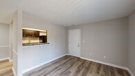 Located at 1326 McIntosh Ln in Anderson, Indiana, this efficiently designed one-bedroom, one-bathroom unit offers a well-organized single-floor layout that makes smart use of every square foot. Light-toned luxury vinyl plank flooring runs throughout the entire unit, providing a clean and cohesive aesthetic from room to room.

The combined kitchen and living area anchors the unit, with the living space benefiting from a large sliding glass door dressed with vertical blinds that invite an abundance of natural light. A pass-through counter connects the living area to the galley-style kitchen, which is outfitted with rich dark espresso cabinetry, granite-style countertops, black appliances including a refrigerator and electric range, and a stainless steel sink — all framed by a practical, corridor layout that maximizes counter and storage space.

The bedroom is a calm, neutral-toned retreat with soft gray walls, a window offering natural light, and a sliding-door closet with a hanging rod for organized storage. The full bathroom features a tiled tub-and-shower combination with brushed nickel fixtures, complementing the unit's consistent, understated finish palette. Clean white trim, neutral walls, and consistent flooring throughout give the space a fresh, move-in-ready feel.