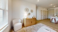 Located at 185 Marquis Way in Freeport, FL, this thoughtfully designed 2-bedroom, 2-bathroom single-story home offers a cohesive, modern coastal aesthetic throughout. Light wood-style flooring and crisp white walls create a bright, airy atmosphere that flows seamlessly from room to room.

The open-concept kitchen is a standout feature, showcasing granite countertops, gray shaker-style cabinetry with black hardware, a white subway tile backsplash, and stainless steel appliances including a refrigerator, range, and over-the-range microwave. A kitchen island with bar seating provides an inviting space for casual dining and entertaining.

The living area is warm and welcoming, with natural light streaming in through windows and a glass-panel entry door, complementing the neutral palette and relaxed coastal feel.

The primary bedroom is a comfortable retreat, featuring a large window with outdoor views, a ceiling fan, and ample natural light. It connects to a well-appointed bathroom with granite-topped vanity, black fixtures, a tub-shower combination, and direct access to a walk-in closet. The second bedroom is equally comfortable and bright, served by a second full bathroom with a granite vanity and a glass-enclosed shower. Both bathrooms echo the home's consistent use of quality finishes and black accent hardware.