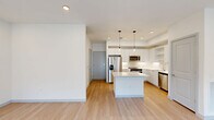 Located in Royal Palm Beach, Florida, this well-designed two-story home offers three bedrooms and four bathrooms across a thoughtfully laid-out floor plan. The ground floor is anchored by an open-concept living, dining, and kitchen area bathed in natural light, with light hardwood-style flooring flowing throughout. The sleek, modern kitchen is a standout feature, showcasing crisp white cabinetry, a subway tile backsplash, stainless steel appliances, pendant lighting, and a central island that serves as both a prep space and casual gathering spot. An attached garage with overhead lighting provides convenient, direct access to the home. Upstairs, the upper floor houses all three bedrooms, offering a spacious and private retreat. The generously sized primary bedroom includes a walk-in closet equipped with built-in wire shelving and storage. The bathrooms are finished in a clean, contemporary style with large-format tile, soaking tub and shower combinations, and modern vanities. Bedrooms feature ceiling fans, light flooring, and windows that invite natural light and outdoor views. Additional highlights include five closets throughout, a dedicated laundry area, and ample hallway space. The home presents a clean, modern aesthetic with a neutral palette ideal for a variety of lifestyles.