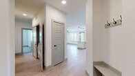 Located at 5400 Haltom Rd in Haltom City, TX, this well-appointed single-story home offers three bedrooms, two bathrooms, and a thoughtfully designed layout. The open-concept kitchen and living area serve as the heart of the home, featuring crisp white shaker cabinetry, stainless steel appliances, a large granite-topped island with pendant lighting overhead, a subway tile backsplash, and light wood-look flooring that flows seamlessly throughout the main living spaces. A ceiling fan and generous windows allow natural light to fill the living area. The bedrooms offer a comfortable retreat, with plush carpeting, ceiling fans, and window treatments providing a calm, private atmosphere. The primary bedroom includes access to a walk-in closet. The bathrooms are finished with granite countertops, gray cabinetry, and matte black hardware accents, with one featuring a tiled tub-shower combination. A dedicated laundry area accommodates a full-size washer and dryer. A built-in entryway nook and panel-style interior doors with matte black hardware add cohesive, modern detailing throughout. The clean, neutral color palette and contemporary finishes create a bright and welcoming ambiance suited for everyday living.