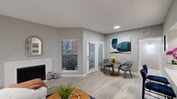 Located at 6000 Ohio Dr in Plano, TX, this 1-bedroom, 1-bathroom residence offers a smartly designed single-story layout that maximizes every square foot. The open-concept living and dining area is bright and welcoming, featuring light wood-style flooring, neutral gray walls, a textured ceiling, and a classic fireplace as a focal point. French doors allow natural light to pour in while offering outdoor views. The kitchen is equipped with stainless steel appliances, gray shaker-style cabinetry, a white quartz countertop, and a breakfast bar with seating — ideal for casual dining. Built-in shelving near the kitchen adds convenient storage and display space. The bedroom is a comfortable retreat, complete with a ceiling fan, a large window with natural light, and direct access to a walk-in closet. The full bathroom features gray cabinetry, a white quartz vanity, a wide mirror with modern lighting, and a tub/shower combination. An in-unit laundry area with a full-size washer provides added convenience. The entrance foyer completes this cohesive, functional layout suited for comfortable everyday living in Plano.