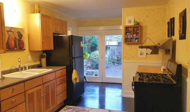 kitchen with gas range, dishwasher and fridge - 993 W 4th Ave