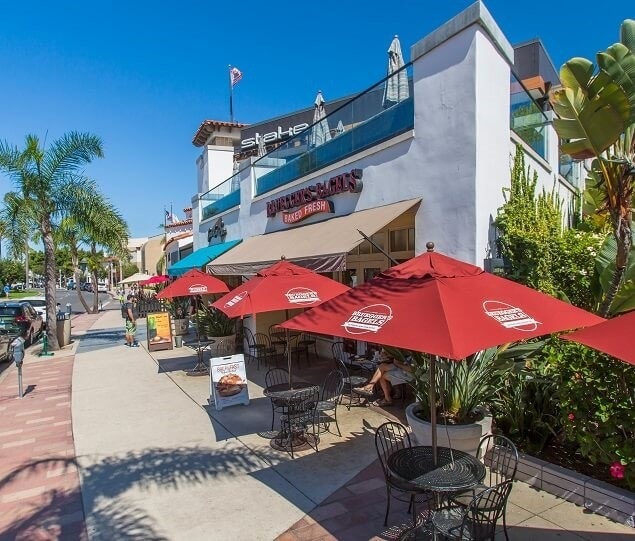 Shops and restaurants with outdoor seating line Orange Avenue