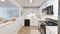 Located at 20 Middlesex Circle in Waltham, MA, this single-floor, 2-bedroom, 1-bathroom home offers a thoughtfully laid-out living space with a clean, modern aesthetic. The kitchen is a standout feature, showcasing white shaker cabinetry with matte black hardware, marble-look countertops, and black appliances including a dishwasher, range, and over-the-range microwave. Light wood-tone flooring runs throughout the kitchen and living areas, lending warmth and continuity to the space. The combined kitchen and living room area provides an open, functional layout ideal for everyday living. The primary bedroom is generously sized, featuring plush carpeting, dual windows with blinds and drapes that invite natural light, and mirrored sliding closet doors. The second bedroom is equally comfortable, also carpeted with a bright window and ample wall space. Both rooms offer a calm, neutral palette. The bathroom is efficiently designed with a tub-shower combination, white tile surround, wood-look flooring, and a window for natural ventilation. A connecting hallway ties the rooms together seamlessly. This home combines practical design with inviting finishes throughout.
