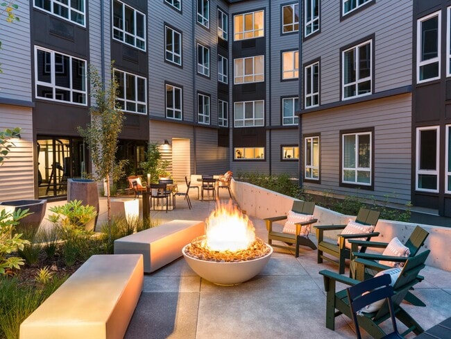 Gather around the inviting fire table on cool evenings or relax amidst vibrant greenery in ample comfortable seating. - Modera Beaverton