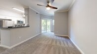 Located at 3663 Solano Ave in Napa, CA, this one-bedroom, one-bathroom residence offers a well-organized single-floor layout designed for comfortable everyday living. The open-concept living room is finished with plush carpet, crown molding, and a ceiling fan, creating a relaxed and inviting atmosphere. A sliding glass door leads to a private balcony, allowing natural light to fill the space and offering pleasant outdoor views. The kitchen is efficiently designed with white cabinetry, dark countertops, wood-look flooring, and stainless steel appliances including a full-size refrigerator — all illuminated by a window that brings in additional natural light. The bedroom is a comfortable, well-proportioned retreat with soft carpet, neutral gray walls, a window with blinds, and a closet with double doors for added storage. A dedicated walk-in closet with wire shelving provides generous organizational space. The bathroom is clean and modern, featuring white vanity cabinetry, a large mirror, bright lighting, and a full tub-shower combination, all complemented by wood-look flooring. The consistent use of neutral tones, crown molding details, and quality finishes throughout give this residence a cohesive and polished feel.