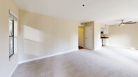 Located at 2550 Hilborn Rd in Fairfield, CA, this well-appointed 2-bedroom, 2-bathroom single-story residence offers a functional and comfortable layout. The open-concept kitchen and living area serves as the heart of the home, where a galley-style kitchen features white cabinetry, dark countertops, stainless steel appliances including a refrigerator, range, microwave, and dishwasher, plus wood-look flooring and a skylight that brightens the space. The kitchen flows seamlessly into the living room, which is highlighted by a tiled fireplace, plush carpeting, and multiple windows framing lush greenery outside. A sliding glass door opens to a private balcony, further connecting the interior to the outdoors. The two bedrooms are carpeted and generously sized, each benefiting from large windows with garden views and ample natural light. Six closets throughout the unit provide abundant storage. The two bathrooms include a clean tub/shower combo and a second bathroom with a stylish dark-wood vanity, white countertop, and modern lighting. A dedicated laundry area and a central hallway connecting all rooms round out this thoughtfully designed residence.