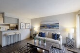 Located in Houston, TX, this one-bedroom, one-bathroom unit offers a well-designed single-floor layout that maximizes every inch of its compact footprint. The open-concept living and dining area serves as the heart of the home, featuring dark hardwood-style flooring, neutral walls, and a textured ceiling that adds subtle character. A large window allows natural light to fill the space, creating a bright and welcoming ambiance. The kitchen follows a galley-style configuration, lined with gray shaker cabinetry, granite countertops, and stainless steel appliances including a refrigerator and electric range. A pantry provides additional storage, and a breakfast bar connects the kitchen to the living area. The bedroom is a generously sized private retreat with its own window and access to multiple closets, offering substantial storage throughout. The bathroom features a granite-topped vanity with an undermount sink, a wide mirror, and hardwood-style flooring that ties seamlessly into the rest of the unit. A dedicated entrance and hallway complete the thoughtful layout. With consistent finishes, ample storage across four closets, and a practical open floor plan, this unit delivers comfortable, functional living in the Bay Area Houston corridor.