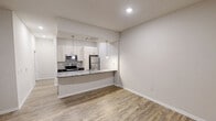 This contemporary 1030 square foot apartment in Charlotte, NC offers a well-designed living space with two bedrooms and two bathrooms. The open-concept layout maximizes the use of space, creating a seamless flow between the living areas. The kitchen is a standout feature, boasting granite countertops, stainless steel appliances, and ample cabinet space. Pendant lighting adds a touch of elegance to the kitchen area. 

The bedrooms are generously sized, with the primary bedroom measuring 180 square feet. Both bathrooms are equipped with modern fixtures, including a bathtub-shower combination with built-in shelving. The apartment features wood-style flooring throughout, lending a warm and cohesive feel to the space.

Comfort and convenience are prioritized with in-unit laundry facilities and a ceiling fan in the living area. The apartment also includes a dedicated closet space for additional storage. Large windows and sliding glass doors in the living room allow for natural light and potential outdoor access. The neutral color palette provides a blank canvas for personal decor preferences. Climate control is ensured with a wall-mounted air conditioning unit, ensuring year-round comfort in this well-appointed Charlotte residence.