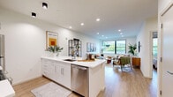 Located at 269 Orange Street in New Haven, CT, this thoughtfully designed one-bedroom, one-bathroom residence offers a well-appointed layout bathed in natural light. The open-concept kitchen and living area serves as the heart of the home, featuring sleek white cabinetry, quartz countertops, a large central island with bar seating, and stainless steel appliances including a dishwasher and refrigerator. Recessed lighting and light wood-toned flooring run throughout, lending a clean, modern aesthetic. The living area is generously proportioned, anchored by a wide window that frames views of surrounding greenery, creating a bright and inviting atmosphere. The bedroom offers a comfortable, quiet retreat with its own large window overlooking lush treetops, a double closet, and warm neutral tones that promote restful living. The bathroom is finished in all-white tile with a glass-enclosed walk-in shower, a floating vanity, and marble-style floor tile, combining minimalist design with functional elegance. Throughout the residence, crisp white walls, consistent flooring, and carefully considered finishes create a cohesive, contemporary living environment well-suited to urban life in New Haven.
