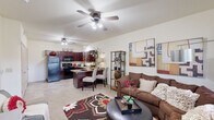 This well-designed one-bedroom, one-bathroom unit in North Little Rock, Arkansas offers an efficient and comfortable layout across a single floor. The open-concept living and kitchen area creates a welcoming, connected atmosphere, anchored by vaulted ceilings and a ceiling fan that add a sense of airiness to the space. The living room features carpet flooring, a large window that invites natural light, and ample room for relaxed seating arrangements.

The kitchen is a standout feature, showcasing rich dark cherry wood cabinetry, granite-style countertops, tile flooring, and a full suite of black appliances including a refrigerator, range, microwave, and dishwasher. A peninsula counter provides additional workspace and casual dining space, seamlessly connecting the kitchen to the living area.

The bedroom is a comfortable retreat, offering carpeted floors, a ceiling fan, and a window with views of the surrounding greenery, filling the room with natural light. A dedicated closet provides convenient storage.

The bathroom is finished with matching dark wood cabinetry, a vanity with a large mirror, tile flooring, and a clean, functional layout. The overall palette throughout the unit is warm and neutral, creating a cohesive and inviting ambiance.