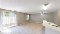 Located at 2613 Nottingham Ln in Monroe, NC, this single-story, 2-bedroom, 1-bathroom home offers a practical and comfortable layout across a well-organized floor plan. Neutral taupe walls, plush carpeting, and textured ceilings are consistent throughout, creating a cohesive and easy-to-personalize interior.

The combined kitchen and living area serves as the heart of the home. The living room is generously sized, featuring a ceiling fan, a large window, and sliding glass doors that open to the outdoors, filling the space with natural light and views of surrounding greenery. The kitchen is equipped with warm oak cabinetry, a light-toned countertop peninsula, black appliances including an electric range and full-size refrigerator, and wood-look flooring.

Both bedrooms are carpeted and feature windows that bring in natural light. The primary bedroom includes a built-in closet with shelving and hanging rods, offering practical storage. The second bedroom features a structural beam detail and a window with outdoor views. A hallway connects the bedrooms to the full bathroom, which includes a tub/shower combination with chrome fixtures and a curved shower rod. A dedicated closet in the hallway provides additional storage throughout the home.