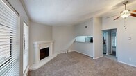 This well-appointed 2-bedroom, 1-bathroom home in Lafayette, Louisiana offers a thoughtfully designed single-floor layout that maximizes comfort and functionality. The living room serves as the heart of the home, highlighted by a charming white-mantled corner fireplace and plush carpeting underfoot. Natural light filters in through slatted blinds on multiple windows, creating a warm and inviting atmosphere. Crown molding and a textured ceiling add classic architectural character throughout.

The kitchen connects seamlessly to the living area via an open pass-through counter topped with granite-style laminate, offering a modern and practical design. It is equipped with stainless steel appliances, including a refrigerator, gas range, and microwave, complemented by light cabinetry and a tile backsplash.

The primary bedroom is generously sized, featuring elegant French doors that invite natural light, along with a ceiling fan and access to a walk-in closet. The second bedroom is carpeted and bright, also fitted with a ceiling fan for added comfort. The bathroom includes a granite-topped vanity with gray cabinetry, a large mirror, and a tub-shower combination. A connecting hallway ties all rooms together efficiently, completing this comfortable and functional home.
