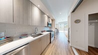 Located at 11690 San Pablo Ave in El Cerrito, California, this single-floor residence offers a thoughtfully designed contemporary living space with clean lines and modern finishes throughout. The open-concept layout connects the living, dining, and kitchen areas seamlessly, creating a bright and functional environment filled with natural light.

The kitchen is a standout feature, showcasing sleek taupe cabinetry extending to the ceiling, a subway tile backsplash, white quartz countertops, and a full suite of stainless steel appliances including a gas range, built-in microwave, dishwasher, and refrigerator. A frosted glass sliding door adds privacy while maintaining a sense of openness. Warm hardwood-style flooring flows throughout the space, unifying each area with a cohesive, inviting aesthetic.

The living area is generously proportioned, offering space for comfortable seating and dining, with a wall-mounted mini-split system ensuring year-round climate control. The bedroom is a calm, well-lit retreat with a closet and tasteful wall accents. The full bathroom features large-format tile flooring, a single-vanity with modern cabinetry, and a full soaking tub with shower. Recessed lighting throughout the unit adds to the bright, airy atmosphere of this well-appointed El Cerrito residence.