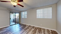 Located at 3225 E Baseline Rd in Gilbert, AZ, this single-floor, 2-bedroom, 2-bathroom home offers a well-organized layout designed for comfortable everyday living. The living room is a bright, open space featuring wood-style plank flooring, a ceiling fan, a textured ceiling, and a sliding glass door that opens to an outdoor patio, allowing natural light to flow freely throughout. Vertical blinds on multiple windows provide privacy while maintaining an airy feel.

The kitchen is a standout, showcasing two-tone cabinetry with crisp white upper cabinets and gray lower cabinets, white countertops, and a full suite of stainless steel appliances including a refrigerator, range, and over-the-range microwave. Wood-style flooring continues through this space, tying the common areas together cohesively.

Both bedrooms offer plush carpeting, ceiling fans, and ample natural light through windows with vertical blinds. The primary bedroom provides a generous footprint with dedicated closet space. Both bathrooms are clean and functional, featuring a tub-shower combination, vanity with sink, and wood-style flooring. A dedicated laundry room with a full-size washer and dryer adds exceptional convenience to this well-appointed home.