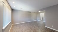 Located at 2908 N Glenhaven Dr in Midwest City, Oklahoma, this single-floor, one-bedroom, one-bathroom home offers a practical and cohesive layout with thoughtful finishes throughout. The open living room is bright and clean, featuring warm wood-look vinyl plank flooring, neutral gray walls, and white trim that create a modern yet inviting atmosphere. The galley-style kitchen is a standout feature, showcasing dark espresso cabinetry, granite-style countertops, a stainless steel sink, and black appliances including a range and refrigerator — offering both style and function in an efficient footprint. The bedroom is comfortably sized, finished with plush carpet, a ceiling fan with light fixture, a window with vertical blinds for natural light, and access to a dedicated closet, providing ample storage. A second closet adds additional storage convenience. The bathroom includes a dark-toned vanity with granite-style countertop, a tub-shower combination with tiled surround, and a window that brings in natural light. A hallway connects the rooms efficiently, completing the well-organized floor plan. This home combines functional design with clean, contemporary finishes throughout.