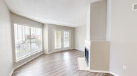 Located in Galveston, TX, this well-designed one-bedroom, one-bathroom residence offers a comfortable and functional layout across a single floor. The open-concept living room and kitchen area serves as the heart of the home, bathed in natural light from large windows and a set of French doors that open to the outdoors. The living room features wood-look luxury vinyl plank flooring, neutral warm-gray walls, a textured ceiling, and a classic fireplace that adds a welcoming focal point to the space. The kitchen is equipped with warm-toned wood cabinetry, granite-look countertops, black appliances including a range, microwave, and dishwasher, and a peninsula that provides additional prep space and a casual dining option. An entry area with a large window offers additional brightness and connects seamlessly to the main living space. The bedroom is a generously sized retreat featuring vaulted ceilings, plush carpeting, a ceiling fan, French doors, and a closet for ample storage. The bathroom is appointed with matching wood cabinetry, granite-look countertops, and a full tub and shower combination with tile surround, maintaining a cohesive design throughout the home.
