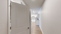 This 890 square foot, single-floor apartment in Deerfield, Illinois offers a blend of modern amenities and comfortable living spaces. The heart of the home is a contemporary kitchen, featuring crisp white cabinetry, granite countertops, and stainless steel appliances, including a sleek range and over-the-range microwave. An island provides additional workspace and casual dining options.

The open-concept living and dining area boasts large windows and a glass door leading to an outdoor space, flooding the room with natural light. Hardwood flooring extends throughout the main living areas, while plush carpeting adds comfort to the bedroom. The spacious 190 square foot primary bedroom includes ample closet space and large windows.

The bathroom features a modern white suite with a combined tub and shower unit. Additional storage is available in a dedicated closet area with wire shelving. Throughout the apartment, recessed lighting and ceiling fans enhance the ambiance and comfort. The neutral color palette and clean lines create a bright, airy feel, making this compact space feel larger and more open.
