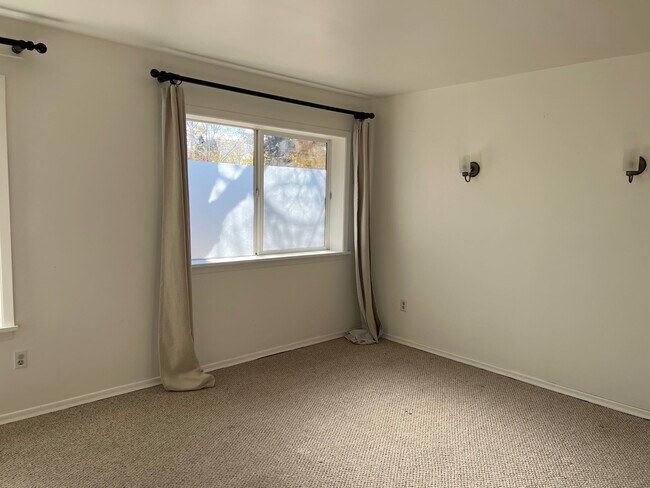 Large bedroom with privacy-screened windows to let in light. - 808 E 6th Ave