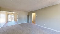 Located at 2800 Gentrytown Dr in Antioch, CA, this single-story, 2-bedroom, 1-bathroom home offers a practical and comfortable layout. The living areas feature neutral-toned carpet and a textured ceiling, creating a clean and understated aesthetic. A wall-mounted heater unit serves the main living space, which connects to a second living area featuring light wood-look flooring, a ceiling fan, and a sliding glass door that opens to an outdoor balcony, allowing abundant natural light to fill the room. The kitchen is equipped with white cabinetry, a granite-style countertop, a stainless sink, a dishwasher, and a refrigerator, all set atop wood-look flooring. Both bedrooms are carpeted and offer windows with outdoor views of surrounding trees, providing a serene atmosphere. The primary bedroom includes a closet with a hanging rod for ample storage. The full bathroom is well-appointed with a tub-shower combination, a white vanity with a speckled countertop, and wood-look tile flooring. A hallway connects the main living spaces to the bedrooms and bathroom, with additional closet storage accessible along the way. The layout is efficient and well-organized throughout.