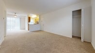Located at 5109 Goldsboro Dr in Hampton, Virginia, this single-floor residence offers a clean, practical layout designed for comfortable everyday living. The living area is finished with wall-to-wall carpet in a warm neutral tone, offering a soft and inviting atmosphere. Natural light filters in through blinded windows, brightening the open space. A pass-through opening connects the living area to the kitchen, maintaining a sense of openness between the two spaces.

The kitchen is efficiently designed with warm oak cabinetry, dark granite-style countertops, and wood-look flooring. It is equipped with stainless steel appliances including a gas range and dishwasher, and features a window above the counter that brings in additional natural light.

The bedrooms are carpeted and well-proportioned, each offering ample closet space. One bedroom includes a double bifold closet system, while another benefits from a spacious walk-in closet with built-in shelving and hanging rods — providing excellent storage capacity.

The bathroom is a standout feature, appointed with hardwood-style flooring, a dual-sink vanity with oak cabinetry and white countertops, a full soaking tub, and a bright window that allows natural light to illuminate the space. The overall design of the unit is clean, neutral, and move-in ready.