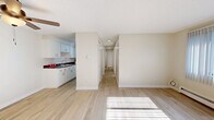 Located at 3131 W Mexico Ave in Denver, Colorado, this single-floor residence offers three bedrooms and two bathrooms within a thoughtfully arranged and efficient layout. The interior is finished with light hardwood flooring throughout, lending a clean, cohesive look to every room.

Each of the three bedrooms is bright and airy, equipped with ceiling fans and windows dressed with vertical blinds that allow natural light to filter in while maintaining privacy. Baseboard heating runs along the exterior walls, ensuring year-round comfort. The primary bedroom includes a sliding-door closet, providing practical built-in storage.

The two bathrooms are finished in a crisp, neutral palette. One features a full tub-shower combination with white surround, a vanity with a white cabinet base and single-basin sink, and a mirrored medicine cabinet. The second bathroom showcases white square tile wainscoting with a subtle accent border, paired with a vanity and light hardwood flooring.

A connecting hallway links the bedrooms and living areas, creating a logical and easy-to-navigate flow. The living area is open and sun-filled, with a large window overlooking the exterior and a baseboard heater beneath it. The overall aesthetic is clean, minimal, and move-in ready, making this Denver residence a comfortable and functional home.