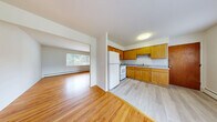 Located at 121 Rose Cir in Middletown, Connecticut, this single-floor, three-bedroom, one-bathroom residence offers a functional and well-organized layout. Warm hardwood flooring runs throughout the main living areas and bedrooms, lending a consistent and inviting aesthetic to the home.

The kitchen is efficiently designed with warm honey-toned wood cabinetry, granite-look countertops, and white appliances including a refrigerator and range. It opens directly into the living room, which benefits from a large window that brings in natural light and frames views of the surrounding greenery. Baseboard heating is present throughout the home, ensuring comfort year-round.

The three bedrooms are clean and simply appointed, each featuring hardwood floors, white walls, and baseboard heating. Several bedrooms include closet space, and the home offers a total of five closets, providing generous storage options. The primary bedroom offers a comfortable amount of personal space.

The bathroom is finished with classic white square mosaic floor tiles and white wall tiles, and includes a full bathtub with shower, toilet, and a window that allows natural light in while maintaining privacy.

A connecting hallway ties the rooms together, contributing to a straightforward and practical floor plan suited for everyday living.