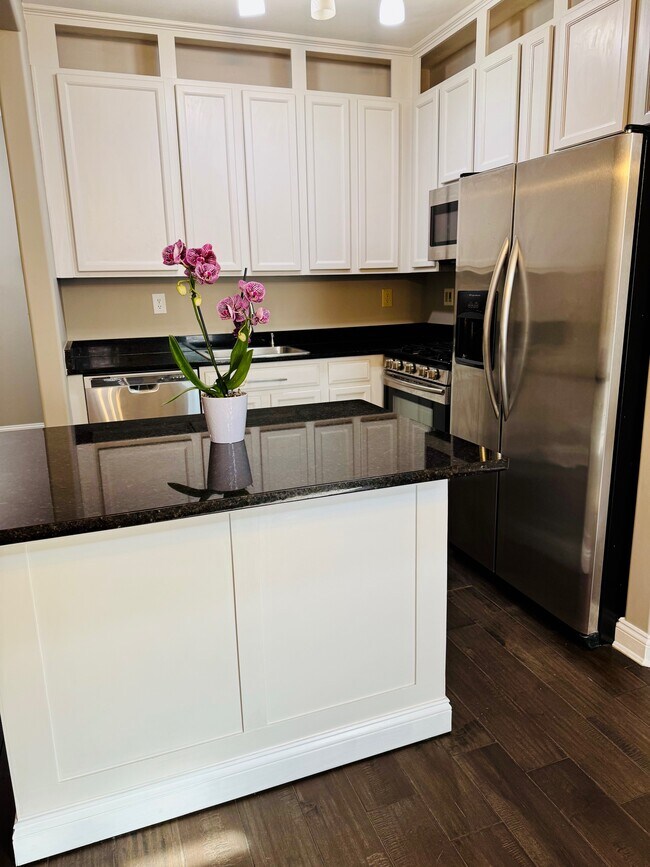 Kitchen with newly renovated cabinets and granite countertops and island seating area. - 131 Meridian Blvd