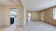 Located at 705 S Beach St in Daytona Beach, Florida, this single-story, 3-bedroom, 2-bathroom home offers a practical and comfortable layout finished consistently with light ceramic tile flooring throughout. The open living area is bright and airy, with warm neutral walls, a textured ceiling, and natural light filtering in through blinds-fitted windows. The layout flows seamlessly from the living room into a central hallway connecting the kitchen, bedrooms, and bathrooms. The galley-style kitchen is well-appointed with white cabinetry, dark granite-style countertops, a stainless steel sink, and a black electric range with overhead ventilation. Both bathrooms are cleanly finished with tile-surround tub-shower combinations, white vanities, and tile flooring. The generously sized primary bedroom includes two closets and a ceiling fan. The additional bedrooms also feature ceiling fans and windows that invite natural light. A dedicated hallway with closets provides convenient storage. The textured ceilings and consistent neutral color palette give the home a cohesive, move-in-ready feel, while the single-floor layout offers ease of accessibility throughout the entire space.