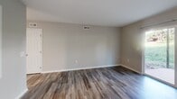Located at 639 Archdale Dr in Charlotte, NC, this 1-bedroom, 1-bathroom residence offers a thoughtfully organized single-floor layout encompassing a living room, kitchen, bedroom, bathroom, hallway, and closet. The living areas feature wood-look laminate flooring in warm gray and brown tones, complemented by neutral taupe walls and clean white baseboards that lend the space a modern, cohesive feel. Natural light filters in through window blinds, brightening the open feel of both the living room and kitchen. The kitchen is a functional galley-style space equipped with white shaker cabinetry, granite-look countertops, stainless steel appliances including a dishwasher and electric range, and a center window that brings in additional daylight. The bedroom is a comfortable, well-proportioned retreat finished with plush wall-to-wall carpeting, neutral walls, and a window that allows natural light to fill the room. A dedicated closet provides ample storage. The bathroom features a full tub-shower combination with clean white tile surround and chrome fixtures, maintaining a crisp and practical aesthetic. Throughout the residence, consistent neutral tones and updated finishes create a clean, move-in-ready environment well suited to comfortable everyday living in Charlotte.