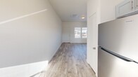 Located at 3040 W Washington St in Stephenville, TX, this 2-bedroom, 1-bathroom unit offers a thoughtfully designed single-floor layout with a clean, modern aesthetic throughout. Light-toned wood-look flooring flows consistently across every room, complementing the crisp white walls and creating a bright, cohesive feel.

The open-concept living, dining, and kitchen area serves as the heart of the home. The kitchen is well-appointed with gray shaker-style cabinetry, dark granite countertops, a stainless steel refrigerator, range, built-in microwave, and dishwasher, along with a window that brings in natural light. A dedicated pantry provides additional storage.

Both bedrooms are comfortably sized, each featuring windows that allow natural light to fill the rooms. The primary bedroom is a practical retreat, with access to one of the three closets found throughout the unit.

The full bathroom is finished with wood-look tile flooring, a white vanity with dark countertop, and a full tub-shower combination with brushed nickel fixtures.

Additional features include multiple closets for ample storage, a dedicated dining space adjacent to the kitchen, and an efficient, functional floor plan ideal for comfortable everyday living.