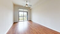 Located at 1235 Nasa Pkwy in Houston, TX, this one-bedroom, one-bathroom residence offers a well-designed single-floor layout that makes efficient use of its space. The open-concept kitchen and living area serves as the heart of the home, featuring rich hardwood-style flooring, dark espresso cabinetry with ample storage, and a sleek white kitchen island. Stainless steel appliances — including a gas range, over-the-range microwave, and French door refrigerator — are complemented by granite countertops and a classic subway tile backsplash. Geometric pendant lights add a modern touch overhead. The living area extends to a private balcony through sliding glass doors, filling the space with natural light and outdoor views. A ceiling fan enhances comfort throughout. The bedroom is a well-proportioned retreat finished with plush carpet, a ceiling fan, and a large window that brings in natural light. It connects directly to a spacious walk-in closet with wire shelving on multiple walls. The bathroom is elegantly appointed with large-format marble-look tile, a glass-enclosed walk-in shower, granite vanity countertop, and clean, neutral finishes throughout.