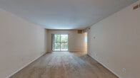 Located at 100 Wellington Lakes Dr in Fredericksburg, VA, this two-bedroom, one-bathroom residence offers a well-organized single-floor layout with a comfortable and functional design. The carpeted living room is generously proportioned, featuring a sliding glass door that opens to a private balcony overlooking lush greenery, filling the space with natural light and outdoor views. Adjacent to the living room, the dining room features warm-toned carpet, a classic chandelier, and a window with garden views, creating a bright and inviting atmosphere for meals. The kitchen is equipped with warm oak cabinetry, a gas range, a double sink, and light countertops, complemented by wood-look flooring and a pantry for additional storage. A hallway connects the main living areas to the two bedrooms, lined with multiple louvered-door closets providing ample storage. The spacious primary bedroom includes a large closet and natural light from a window. The second bedroom also features plush carpet and a bright window. The full bathroom offers a tub-shower combination, a wood-toned vanity, and wood-look flooring. With four closets throughout, this residence offers practical storage solutions alongside a comfortable, light-filled living environment.