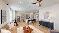 This well-appointed 1-bedroom, 1-bathroom residence in Baton Rouge, Louisiana offers a thoughtfully designed open-concept layout with modern finishes throughout. Light hardwood flooring flows seamlessly across the entire living space, creating a warm and cohesive aesthetic.

The open kitchen is a standout feature, equipped with stainless steel appliances including a refrigerator, range, and microwave, complemented by gray shaker-style cabinetry, light granite countertops, and a subway tile backsplash. A central island with seating for multiple bar stools serves as both a prep area and casual dining space.

The kitchen opens directly into the living room, which is bright and airy thanks to large windows and a sliding glass door that provides access to an outdoor area. A ceiling fan adds comfort to the space.

The bedroom is a comfortable retreat featuring a ceiling fan, a large window with outdoor views, and direct access to the bathroom. The bathroom continues the refined aesthetic with gray cabinetry, granite countertops, and hardwood-style flooring.

Recessed lighting and abundant natural light throughout enhance the open, modern ambiance of this Baton Rouge residence.