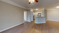 Located at 11010 Eastlake Club Way in Raleigh, NC, this single-floor residence offers a well-designed layout with a seamless blend of comfort and functionality. The open-concept living area features smooth hardwood-style flooring, neutral gray walls, and elegant crown molding, creating a bright and welcoming atmosphere. Ceiling fans with integrated lighting are present throughout, enhancing both comfort and style.

The kitchen is a standout feature, equipped with crisp white cabinetry, granite countertops, a classic subway tile backsplash, and stainless steel appliances. A raised breakfast bar peninsula connects the kitchen to the main living area, making it ideal for both everyday meals and entertaining.

The bedrooms are finished with plush carpeting and include ceiling fans, ample natural light from large windows, and access to closet space. Each room maintains the home's consistent neutral palette, offering a calm and restful environment.

The bathrooms are clean and well-appointed, each featuring a tub-shower combination with decorative tile accents, a white vanity with sink, and hardwood-style flooring. The layout ensures easy access between bedrooms and bathrooms throughout the residence.

Overall, this home delivers a cohesive, move-in-ready interior with thoughtful finishes and a practical, comfortable design.