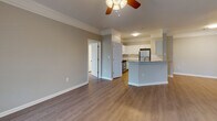 Located at 11010 Eastlake Club Way in Raleigh, NC, this single-floor residence offers a well-designed layout with a seamless blend of comfort and functionality. The open-concept living area features smooth hardwood-style flooring, neutral gray walls, and elegant crown molding, creating a bright and welcoming atmosphere. Ceiling fans with integrated lighting are present throughout, enhancing both comfort and style.

The kitchen is a standout feature, equipped with crisp white cabinetry, granite countertops, a classic subway tile backsplash, and stainless steel appliances. A raised breakfast bar peninsula connects the kitchen to the main living area, making it ideal for both everyday meals and entertaining.

The bedrooms are finished with plush carpeting and include ceiling fans, ample natural light from large windows, and access to closet space. Each room maintains the home's consistent neutral palette, offering a calm and restful environment.

The bathrooms are clean and well-appointed, each featuring a tub-shower combination with decorative tile accents, a white vanity with sink, and hardwood-style flooring. The layout ensures easy access between bedrooms and bathrooms throughout the residence.

Overall, this home delivers a cohesive, move-in-ready interior with thoughtful finishes and a practical, comfortable design.
