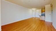 Located at 550 N Figueroa in downtown Los Angeles, this 2-bedroom, 2-bathroom residence offers a well-designed single-floor layout. The open-concept living room is a bright, welcoming space featuring warm hardwood flooring, crown molding, and a seamless connection to the kitchen. Large windows flood the living area with natural light and frame views of the surrounding cityscape, while a sliding glass door leads to a private balcony where palm trees and urban scenery can be enjoyed.

The kitchen is efficiently designed in a galley style, featuring light wood cabinetry, dark granite countertops, tile flooring, and a full suite of stainless steel appliances including a gas range, built-in microwave, refrigerator, and dishwasher.

The spacious primary bedroom includes hardwood floors, a dedicated walk-in closet with built-in shelving, and direct access to an en-suite bathroom. The second bedroom offers comparable hardwood flooring and ample room. Both bathrooms are finished with tile flooring, wood vanities with granite countertops, and glass-enclosed tub/shower combinations. A second bathroom features a window for added natural light and ventilation. Hallways connect all rooms efficiently throughout the residence.