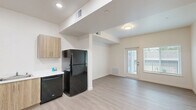 Located at 771 Harrington Way in Folsom, CA, this one-bedroom, one-bathroom unit offers a thoughtfully designed single-floor layout. Light wood-look vinyl plank flooring runs consistently throughout, creating a clean and cohesive aesthetic.

The open kitchen anchors the main living area and is outfitted with warm-toned wood laminate cabinetry, white countertops, and black appliances including a gas range, dishwasher, and full-size refrigerator. A range hood, under-cabinet lighting, and recessed ceiling lights ensure a well-lit and functional cooking space. The kitchen flows directly into the main living area, which is bright and open with recessed lighting and clean white walls.

The bedroom is a cozy, well-proportioned room featuring a window with horizontal blinds that allows natural light and outdoor views. The clean white walls and light flooring give the room an airy feel.

The bathroom is finished with the same light flooring found throughout the unit, complemented by a wood-toned vanity with a white countertop. The spacious layout includes a toilet and towel bar, with clean, neutral walls providing a simple and functional design.

The unit presents a modern, move-in-ready interior with a neutral palette, consistent finishes, and efficient use of space throughout.