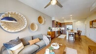 Located at 2850 Southwest 71st Avenue in Miami, FL, this thoughtfully designed one-bedroom, one-bathroom residence offers a comfortable and stylish living experience. Light wood flooring flows throughout, tying together the open-concept floor plan with a warm, cohesive aesthetic.

The living room is a welcoming space anchored by a ceiling fan, natural light from large windows with outdoor views, and bohemian-inspired wall décor. It connects seamlessly to the kitchen and dining area, creating an ideal layout for everyday living and entertaining.

The kitchen is a standout feature, outfitted with rich wood cabinetry, a white tile backsplash, stainless steel appliances including a French door refrigerator, gas range, and built-in microwave, plus a white quartz island with bar seating for multiple guests.

The bedroom is a well-proportioned retreat filled with natural light from a large window. It features a ceiling fan, soft neutral tones, and access to ample closet space — complemented by three closets throughout the residence.

The bathroom offers a sleek, elongated design with warm wood vanity cabinetry, white countertops, a large mirror, and clean, modern finishes. The space balances practicality and style in every detail.