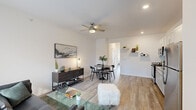 This well-appointed 1-bedroom, 1-bathroom unit in Oak Park, Michigan, offers a thoughtfully designed layout that maximizes every square foot. The open-concept living and dining area serves as the heart of the home, featuring light-toned hardwood-style flooring, crisp white walls, and a ceiling fan with integrated lighting. Large windows and a front entry door with transom glass flood the space with natural light while offering views of the surrounding outdoors. Decorative floating wall shelves add a modern, functional touch to the dining area.

The kitchen is efficiently designed with white shaker-style cabinetry, granite-look countertops, and a full suite of stainless steel appliances, including a range, microwave, and refrigerator. Recessed lighting and continued hardwood-style flooring maintain the clean, cohesive aesthetic throughout.

The generously sized bedroom features dual windows that bathe the room in natural light, a ceiling fan, and hardwood-style flooring, creating a bright and airy retreat. A connecting hallway provides access to the bathroom and additional storage. The unit's neutral color palette and modern finishes contribute to a clean, contemporary ambiance throughout.