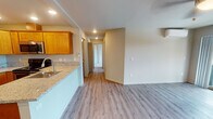 Located at 2530 SW Cherry Park Rd in Troutdale, Oregon, Unit 254 is a thoughtfully designed single-floor residence that combines modern finishes with functional living spaces. The open-concept layout connects the kitchen and living area seamlessly, creating an inviting and cohesive environment. The kitchen is a standout feature, showcasing warm honey-toned shaker cabinetry, granite countertops, a peninsula with an undermount sink, and a full suite of stainless steel appliances including a refrigerator, electric range, and built-in microwave. Recessed lighting and a chandelier accent illuminate the space with warmth. The living area features light wood-look luxury vinyl plank flooring, a ceiling fan, a wall-mounted mini-split unit for climate control, and sliding glass doors that open to a private balcony with outdoor views. The bedrooms are generously proportioned, finished with plush carpeting and large windows that bring in natural light. The bathrooms are clean and functional, offering both a soaking tub with shower combination and a separate walk-in glass-enclosed shower. The neutral color palette throughout creates a bright, move-in-ready atmosphere well-suited for comfortable everyday living.