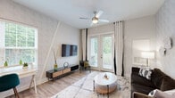 Located at 150 Country Squire in Cromwell, Connecticut, this thoughtfully designed one-bedroom, one-bathroom residence offers a well-organized single-floor layout that maximizes comfort and functionality. Light wood-look flooring flows throughout the main living areas, lending a warm, cohesive aesthetic.

The kitchen is a standout feature, showcasing crisp white shaker cabinetry, a classic subway tile backsplash, and gleaming granite countertops. A large central island with pendant lighting provides both additional prep space and casual seating for multiple guests, while stainless steel appliances complete the modern, polished look.

The living room is bright and welcoming, anchored by full-height French doors that flood the space with natural light and offer views of the surrounding greenery. The open layout connects seamlessly to the kitchen, making it ideal for entertaining.

The bedroom is a serene retreat, featuring plush carpeting, a ceiling fan, and a large window that frames pleasant outdoor views. A dedicated closet offers organized storage, and direct access to the full bathroom adds everyday convenience. The bathroom is well-appointed with a dual-sink vanity, grey cabinetry, and wood-look flooring that ties back to the rest of the home.

Two hallways connect the spaces efficiently, and a separate closet provides additional storage throughout this refined and move-in-ready residence.