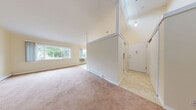Located at 151 Andrew Ave in Naugatuck, CT, this one-bedroom, one-bathroom unit offers a thoughtfully arranged single-floor layout. The combined living and dining area is the heart of the home, featuring soft carpet flooring, warm neutral walls, and a notably elevated ceiling that lends a sense of openness. Large windows along multiple walls allow abundant natural light to fill the space while framing views of the surrounding greenery. Baseboard heating and a wall-mounted air conditioning unit provide year-round climate control throughout.

The galley-style kitchen is efficiently designed with white cabinetry, granite-look countertops, a textured tile backsplash, and white appliances including a range, microwave, and refrigerator. Tile flooring and a pendant light overhead complete the functional workspace. A tiled entryway greets residents at the front door, providing a clean transition into the main living areas.

The bedroom is a generously sized room with carpet flooring, soft neutral walls, a large window with outdoor views, and its own closet access. The full bathroom features a clean, white tub-shower combination with built-in shelving. Three total closets throughout the unit offer ample storage for everyday living.