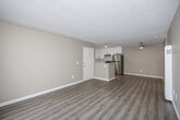 Located at 652 Moss St in Chula Vista, CA, this one-bedroom, one-bathroom unit offers a practical and well-appointed single-floor layout. The open-concept living, dining, and kitchen area creates a seamless flow, anchored by light-toned vinyl plank flooring that runs throughout the unit. Warm beige walls and textured ceilings provide a neutral backdrop, while a ceiling fan adds comfort to the living space.

The kitchen is a standout feature, showcasing white shaker-style cabinetry with matte black hardware, marble-look countertops, a stainless steel refrigerator, gas range, and dishwasher — all complemented by ample upper and lower cabinet storage. A peninsula with a sink connects the kitchen to the main living area.

The living room receives generous natural light through a sliding glass door fitted with vertical blinds, opening directly to a private patio with outdoor views. The spacious bedroom includes a sliding mirrored closet and a bright window. Three closets throughout the unit offer notable storage capacity. The bathroom features a full tub-shower combo with clean white surroundings. The overall ambiance is bright, clean, and functional.