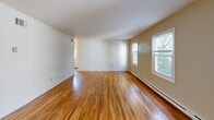 Located at 37 Farmhouse Ln in Morristown, NJ, this single-floor residence offers a well-organized layout with 2 bedrooms, 2 bathrooms, a living room, dining room, kitchen, and five closets providing generous storage throughout. Warm hardwood floors flow across the living, dining, and bedroom areas, reflecting natural light that pours in through multiple windows. The spacious living room features large windows with views of the surrounding greenery, creating a bright and welcoming atmosphere. The galley-style kitchen is equipped with warm wood cabinetry, white appliances including a range, microwave, and refrigerator, and light tile flooring, with direct access to an entry door. The generously sized primary bedroom includes two closets and a window overlooking the outdoors, while the second bedroom also benefits from natural light and hardwood floors. The full bathroom features floor-to-ceiling earth-toned tile, a tub-shower combination, and a window, while the second bathroom offers a wood-toned vanity, tile flooring, and a bright window. Baseboard heating is present throughout the residence. The overall ambiance is clean, functional, and comfortable, well-suited for everyday living in a convenient Morristown location.
