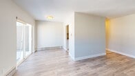 Located at 75 Mary St in Chatham-Kent, Ontario, this one-bedroom, one-bathroom unit offers a well-organized single-floor layout designed for comfortable everyday living. The open-concept living, dining, and kitchen area forms the heart of the space, finished with light wood-look flooring and neutral warm-toned walls that create a clean, welcoming atmosphere throughout. Large windows and a sliding glass door flood the living area with natural light and provide direct access to a private balcony with outdoor views, enhancing the sense of openness. The kitchen is equipped with stainless steel appliances, including a full-size refrigerator and range, set against light-toned cabinetry and tile flooring. The bedroom offers a cozy and functional retreat, featuring the same light wood flooring, crisp white baseboards, and a closet with a sliding door. Baseboard heating is present throughout the unit. The bathroom is finished with classic white subway tile surrounding a full soaker tub and shower combination, complemented by chrome fixtures for a timeless, clean look. Overall, the unit presents a bright, move-in ready space with a simple and practical design suited for single occupants or couples in the heart of Chatham-Kent.